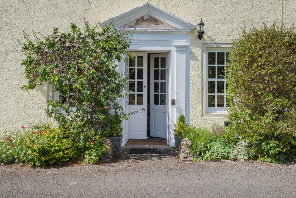 Front door view with trees and plants